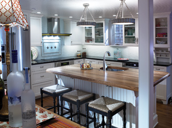 The kitchen’s center island is topped with unique zebrawood. Copyright Don Pearse Photographers Inc.