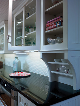 Custom Shaker-style cabinets help to preserve open space in the kitchen. Copyright Don Pearse Photographers Inc.