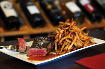 The 12-ounce, center-cut, Black Angus New York strip steak is served with hand-cut fries. Photograph by Thom Thompson
